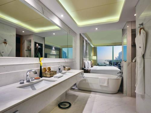 a bathroom with a large tub and a sink and a toilet at Crowne Plaza Suzhou by IHG in Suzhou