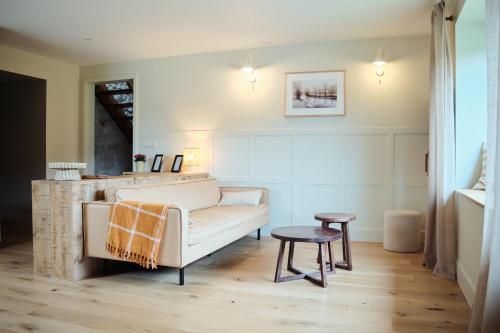 een woonkamer met een bank en een tafel bij Penthouse : immersion dans la nature in Durbuy