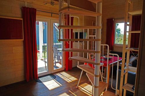 a room with a book shelf and a room with windows at Feriendorf Wutachschlucht in Mundelfingen