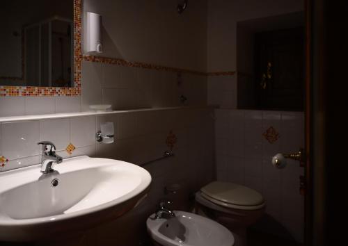 a bathroom with a sink and a toilet at Mirose's holiday home in Castelbuono