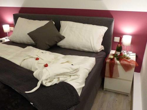 a bed with a white shirt on top of it at 4 Sterne Ferienwohnung Schlossblick Sauna Pool Whirlpool pri in Braunfels