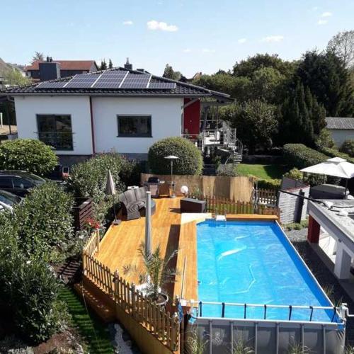 an overhead view of a swimming pool with a house at 4 Sterne Ferienwohnung Schlossblick Sauna Pool Whirlpool pri in Braunfels