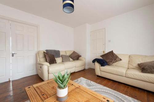 a living room with two couches and a coffee table at Cheerful Chingford, Beautiful Views, Free Parking in Ponders End
