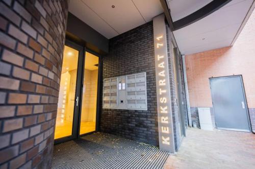 a brick building with a sign on the side of it at Alphabet Studio Apartments Penthouse KS71 in Hilversum