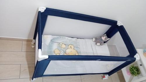 a blue crib with stuffed animals in it at Sunflower Guest House - Madalena - Pico in São Caetano