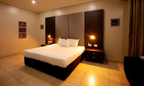 a bedroom with a large bed in a room at Genesis Reventon Hotel in Port Harcourt
