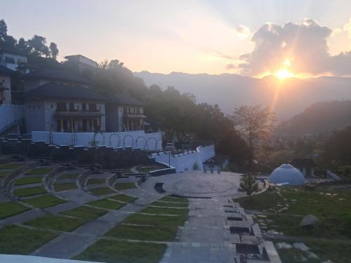 a view of a sunset from the top of a building at Purna in Pokhara