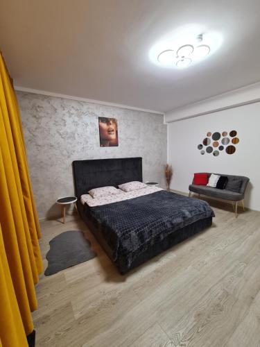 ein Schlafzimmer mit einem großen Bett und einem Sofa in der Unterkunft Studio By Raisa in Braşov