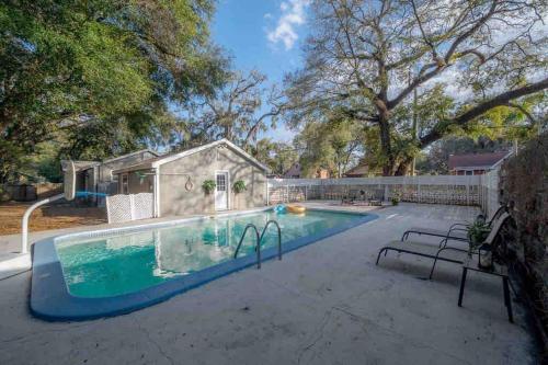 a swimming pool in a yard with a house at Pool house w/lg yard in the heart of Tampa in Tampa