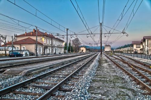 a set of train tracks in a town with houses at Guesthouse Jersin in Logatec