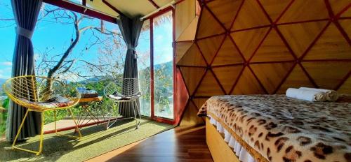 a room with a bed and a large window at Nature Homes Đà Lạt in Da Lat