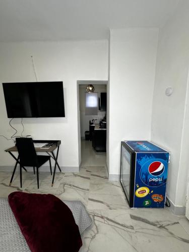 a living room with a pepsi box and a table at Airport17 B&B in Vecsés