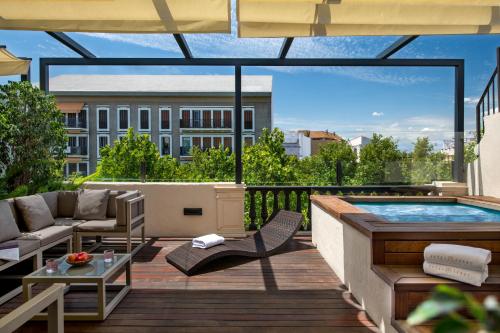 a patio with a hot tub and a pool at Hotel Lobby in Seville
