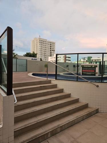 a set of stairs in a city with buildings at Ap. Novo Maceió - praia de Ponta verde in Maceió