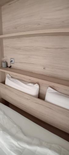 a bedroom with two bunk beds with white pillows at Apartamento La Fuente 27 in Tomares
