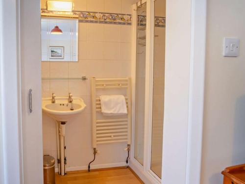 a small bathroom with a sink and a shower at 4 Bed in Shanklin IC068 in Shanklin