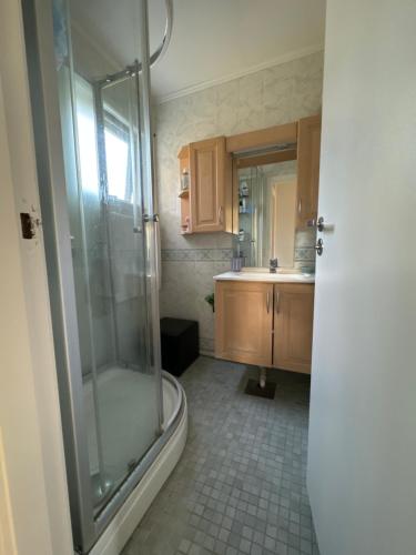 a bathroom with a shower and a sink at House close to Ålesund center in Ålesund