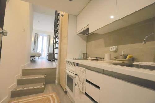 a kitchen with a sink and a counter top at Estudios Plaza Comendadora in Madrid