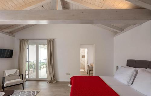 a bedroom with a large bed with a red blanket at 3 Bedroom Cozy Home In Bregi in Breza