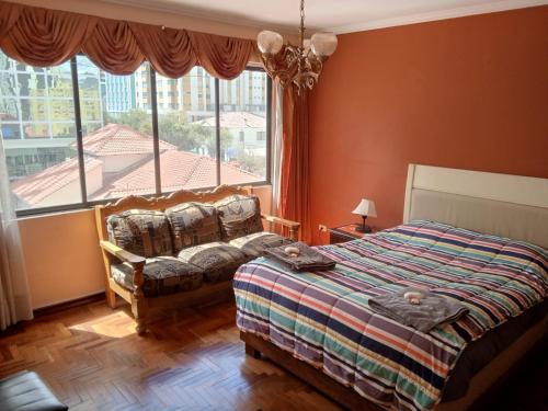 ein Schlafzimmer mit einem Bett und einem großen Fenster in der Unterkunft Hermosa Habitación en Av Arce frente a Multicine in La Paz