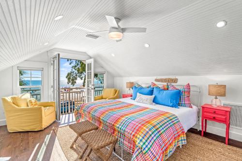 a bedroom with a bed and a balcony at Salty Sister - 302 in Anna Maria