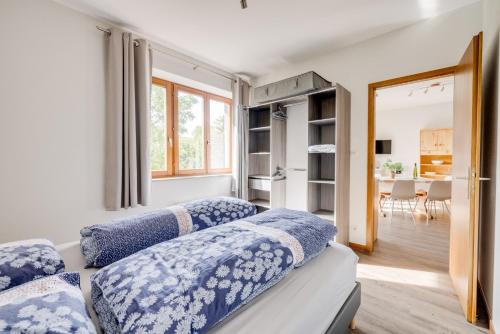 a room with two beds with blue and white pillows at SARL HARTWEG Les Amandiers in Beblenheim