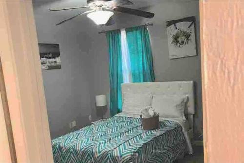 a bedroom with a bed and a ceiling fan at Exciting 2 B/1 b near FSU /FAMU. in Tallahassee