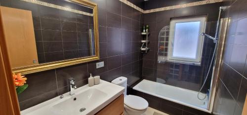 a bathroom with a sink and a toilet and a tub at Mina La Camocha · 2 Hab · 4 pax · Wifi in Gijón