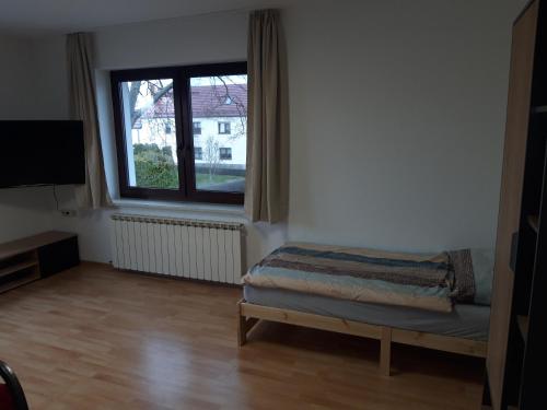 a room with a bed and a large window at Vermietung Hänsel in Thiendorf