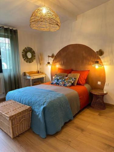 a bedroom with a large bed with a large wooden headboard at La tanière in La Broque