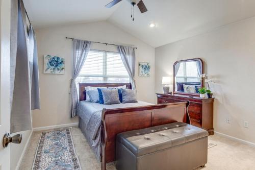 a bedroom with a bed and a dresser and a mirror at 12 Mi to DIA Cozy Denver Townhome with Fireplace! in Aurora