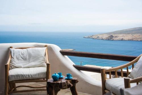 a balcony with chairs and a view of the ocean at Apt with Amazing Balcony View of Mykonos in Agios Sostis Mykonos