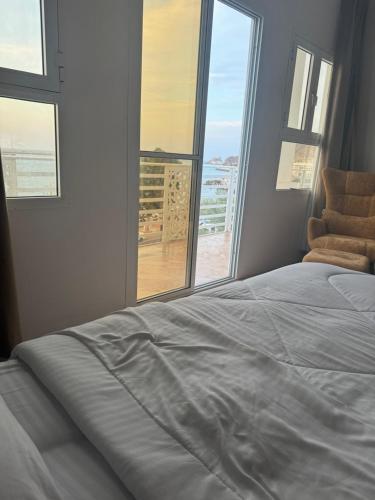 a bedroom with a bed and a view of the ocean at Muttrah Souq and Sea View in Muscat