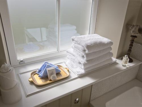 a pile of towels sitting on a counter in a bathroom at 1 Bed in Pateley Bridge G0026 in Pateley Bridge