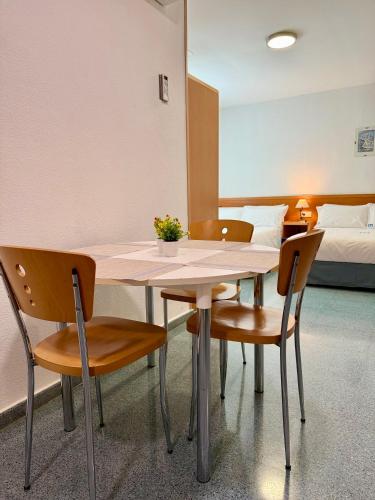 a table and chairs in a room with a bed at Residencia Mediterraneo in San Vicente del Raspeig