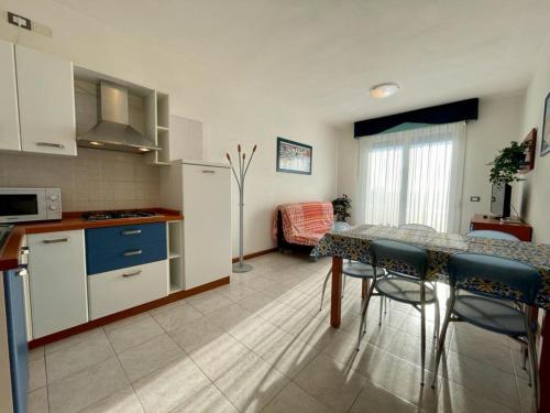 a kitchen and dining room with a table and chairs at Lovely flat overlooking the pool in Veneto