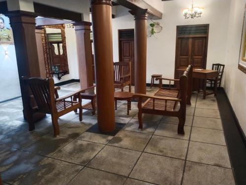 a dining room with wooden tables and chairs at Rebel de Pondiche'ry in Pondicherry