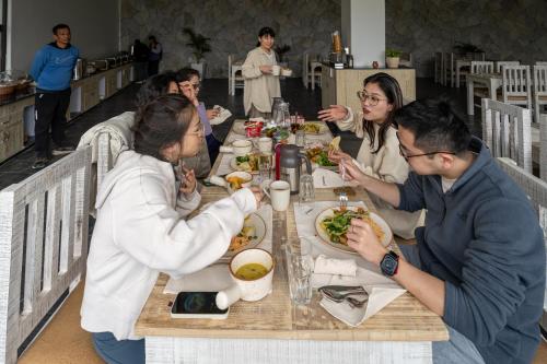a group of people sitting at a table eating food at Purna in Pokhara