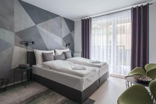 a bedroom with a large bed and a large window at Intimate Ground-Floor Hideaway - 011 in Budapest