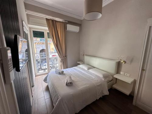 ナポリにあるB&B Partenopeoのベッドルーム(白いベッド1台、窓付)