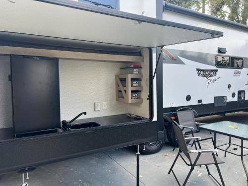 an rv with a sink and a table and chairs at Free BBQ in RV With Private entrance in Homestead