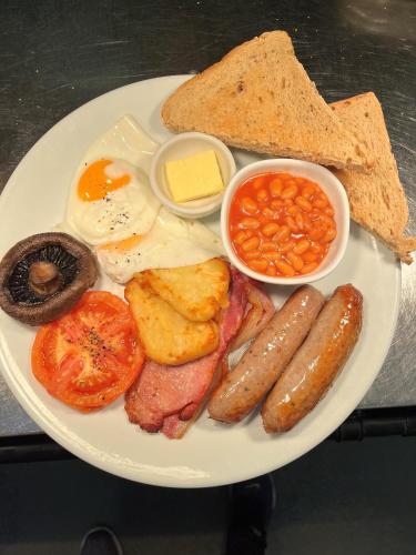 a plate of breakfast food with eggs sausage beans and toast at The Ferry Boat Inn in North Fambridge
