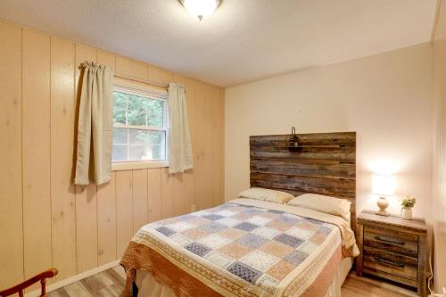 a bedroom with a bed and a window at River Access and Hot Tub Cozy Hot Springs Cabin in Hot Springs