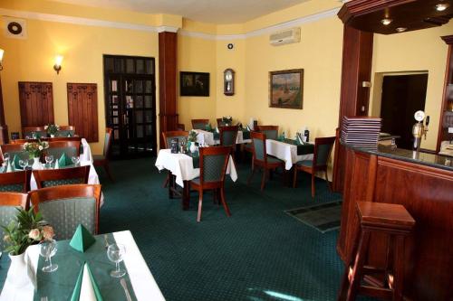 a dining room with tables and chairs in a restaurant at Hotel P7 in Lučenec