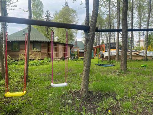 a group of swings in front of a cabin at Agroturystyka Gajewo in Suchowola