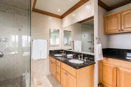 a bathroom with two sinks and a shower at Solana Beach Home 4 blocks from the Ocean in Solana Beach