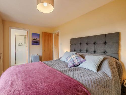 a bedroom with a large bed with two pillows at 1 Bed in Whitegate 91266 in Whitegate
