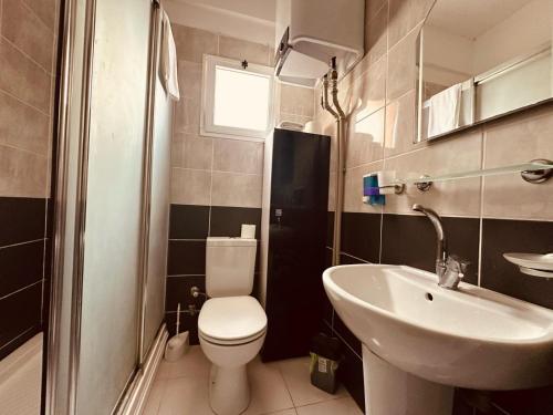 a small bathroom with a toilet and a sink at 2-Bedroom Apartment Pamfilya 7 by MyGuest Cyprus in Famagusta