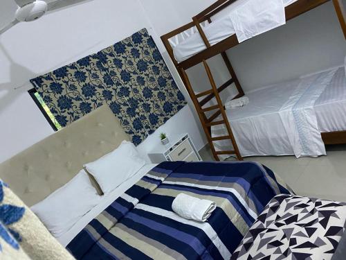 a bedroom with two beds and a ladder at Apartamento JGB in Sosúa