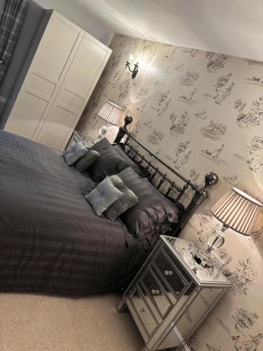 a bedroom with a large bed with a table at Luxury Farm Country Retreat in Chippenham